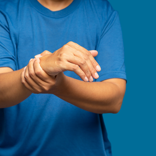 Close-up of a wrist being rubbed, showing hand fatigue and grip strain from daily use.