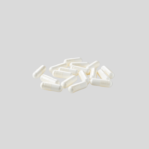 Pile of generic white capsules on gray background (comparison).