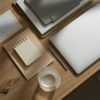 Organized desk flat lay with notebook and laptop—signals clear start and all-day focus (Lion’s Mane nootropic).