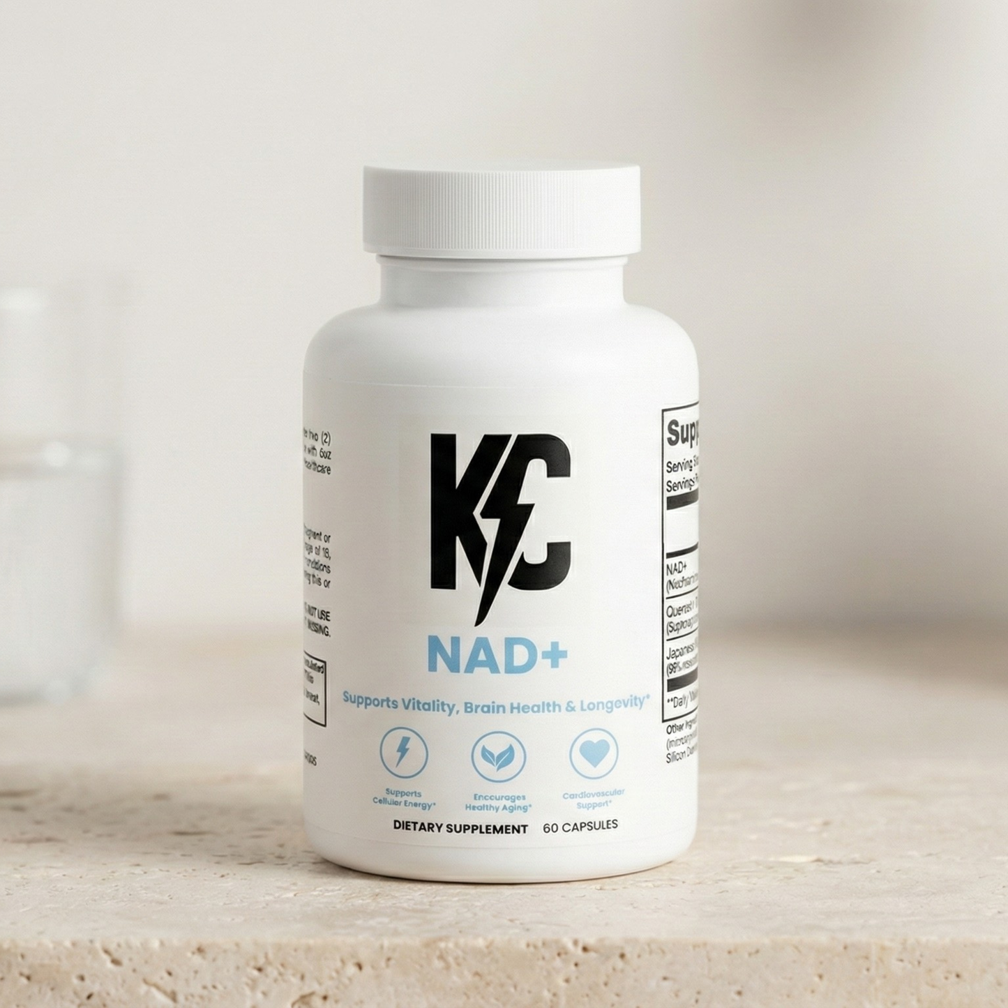 KC NAD+ dietary supplement bottle on a neutral stone surface with a glass of water and plant in the background